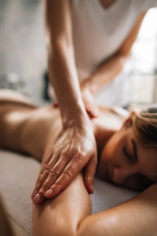 A woman receiving a soothing shoulder and upper-back massage