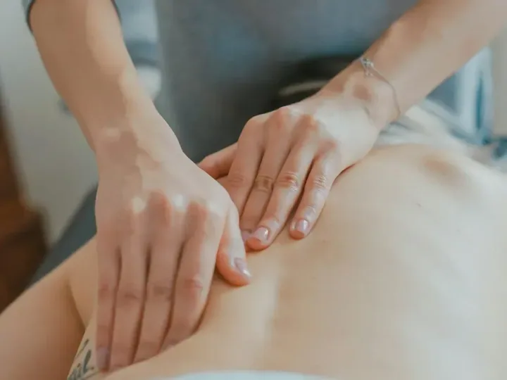 A therapist applying palm pressure during a relaxing back massage